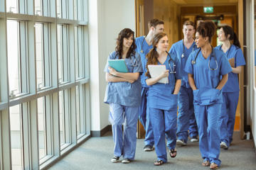 Young Doctors Walking Through Corridor