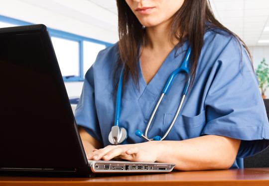 Doctor using laptop